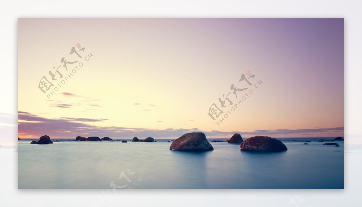 沿海海边岩石夕阳图片